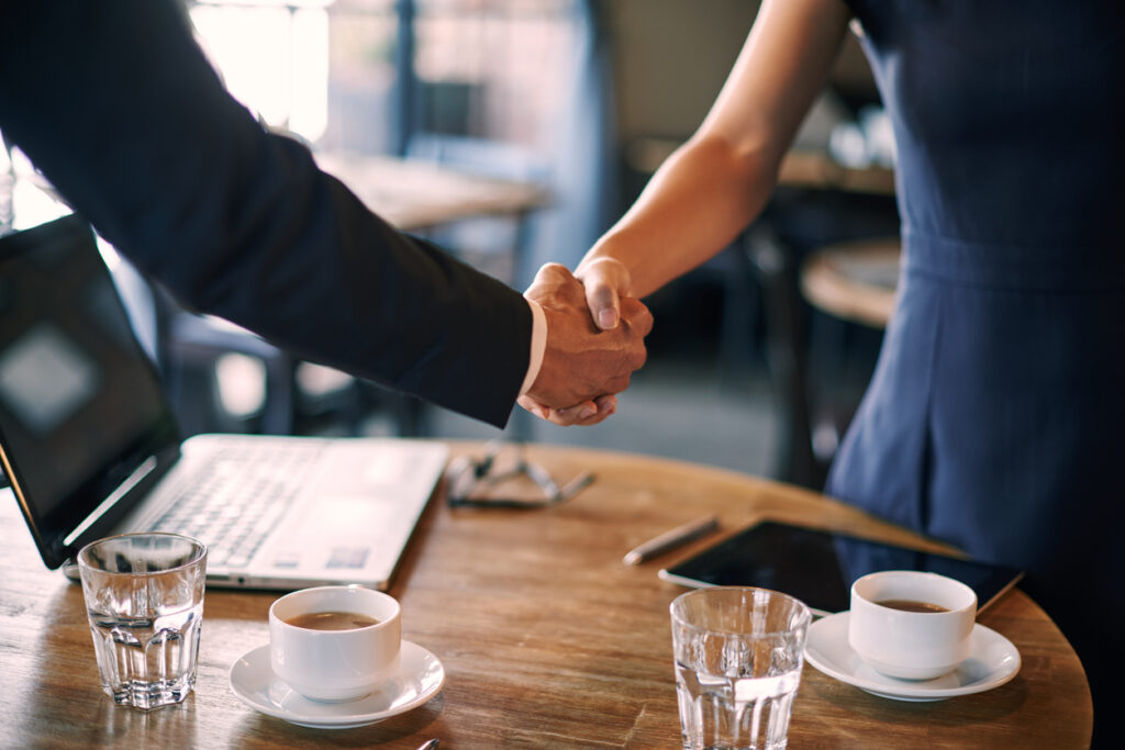 Switch to Optima discussion of partnership in cafe